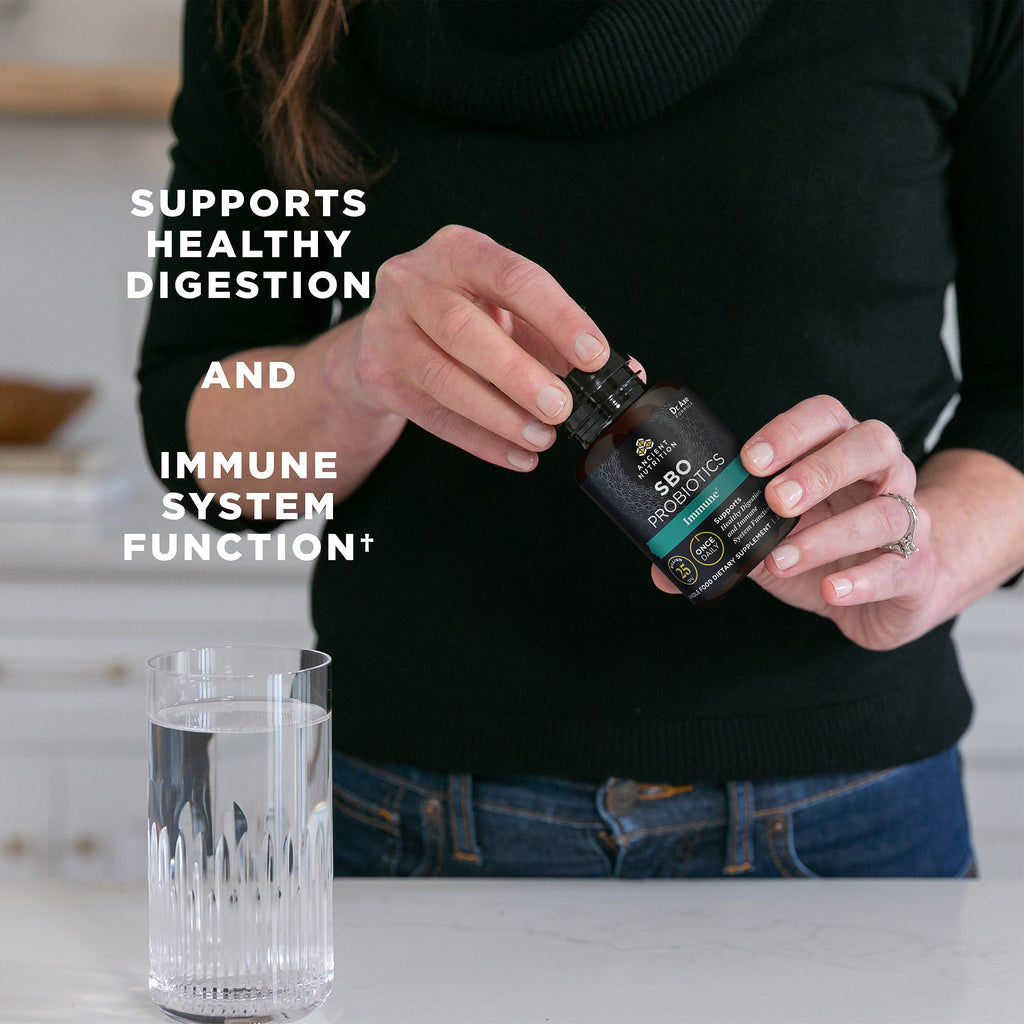 woman holding SBO Probiotics Immune Once Daily