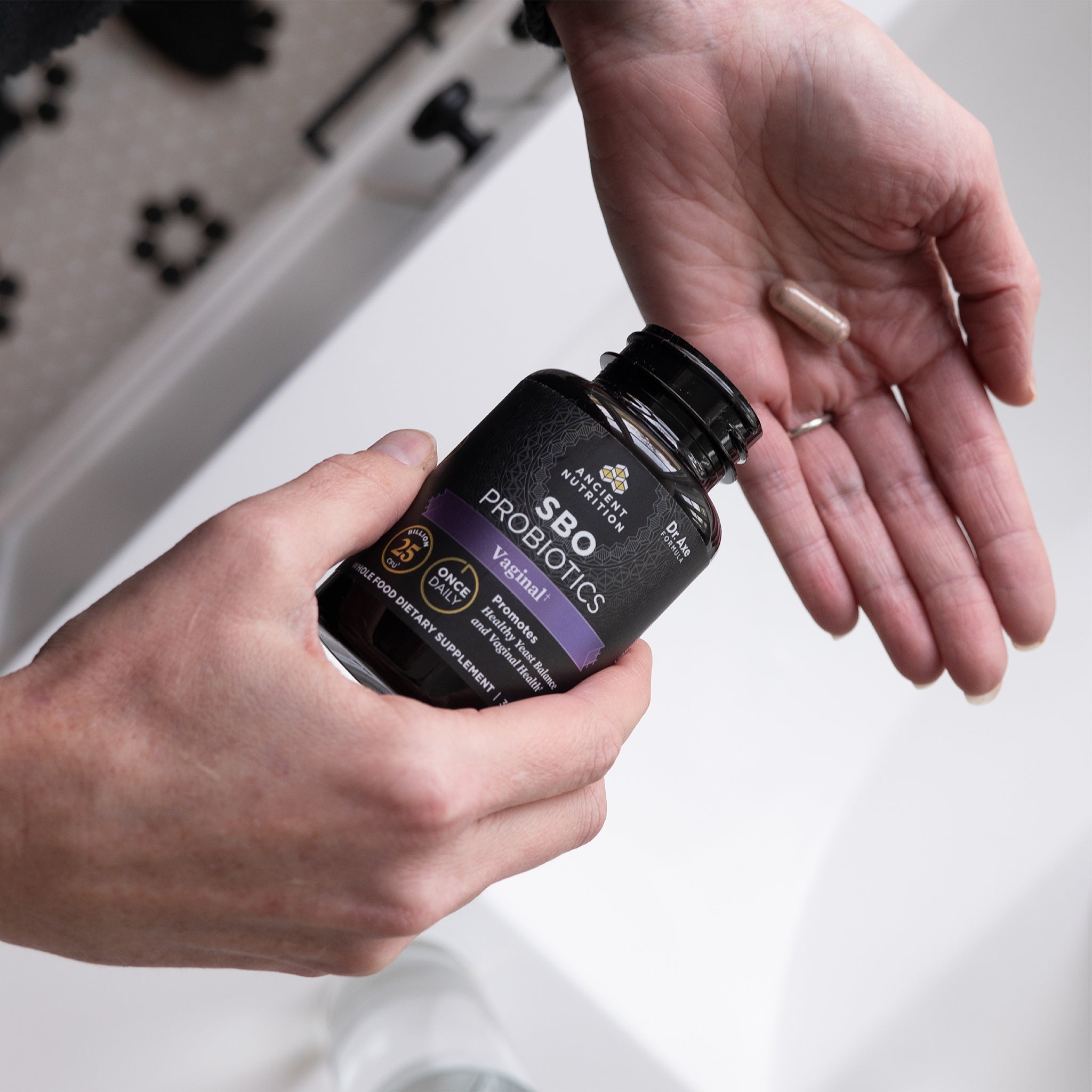 person putting SBO Probiotics Vaginal Once Daily capsules in hand