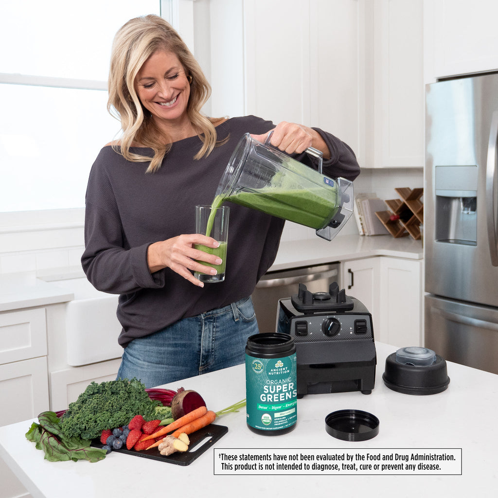 a woman pouring a green smoothie