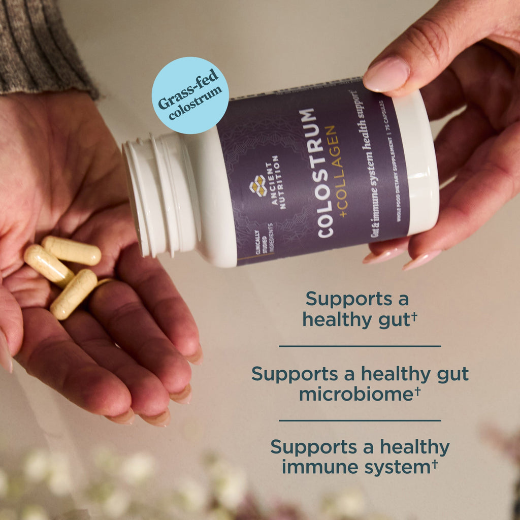 Person holding a container of colostrum with text highlighting benefits on a neutral background