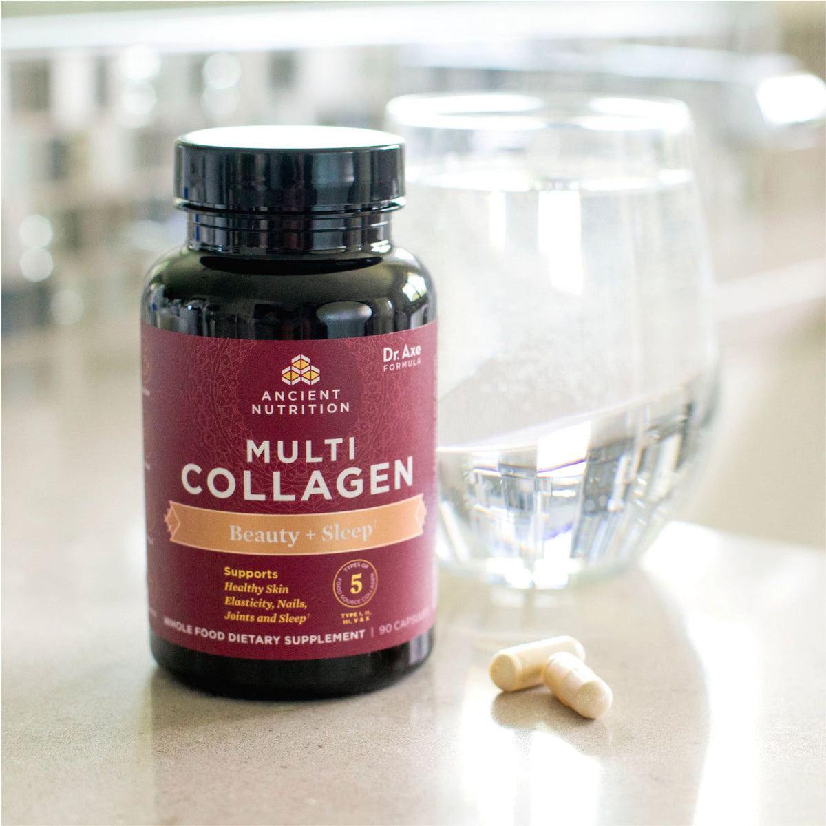 Bottle of Multi Collagen Beauty & Sleep Support Capsules next to a glass of water