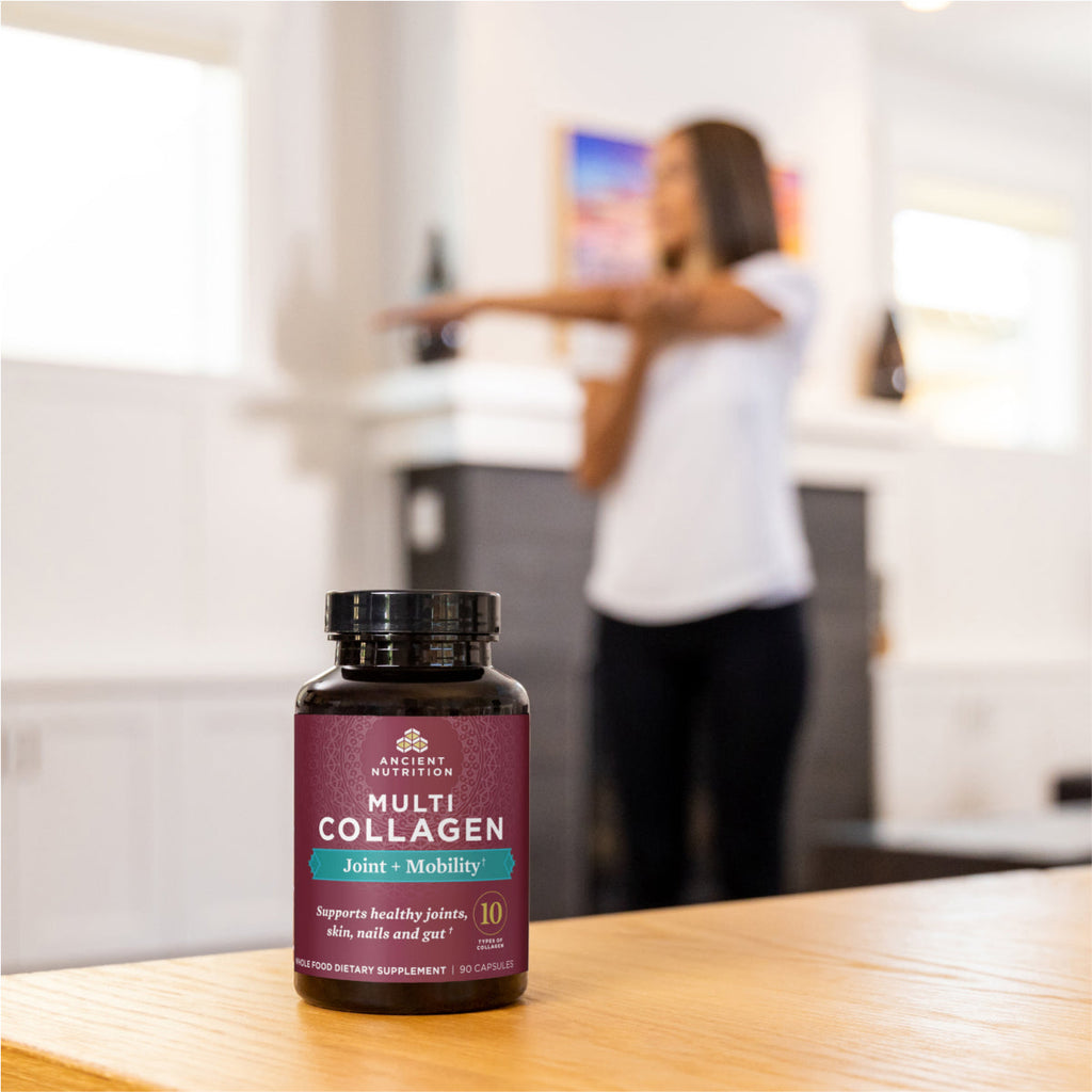 a bottle of Multi Collagen Joint & Mobility Capsules with a woman stretching in the background
