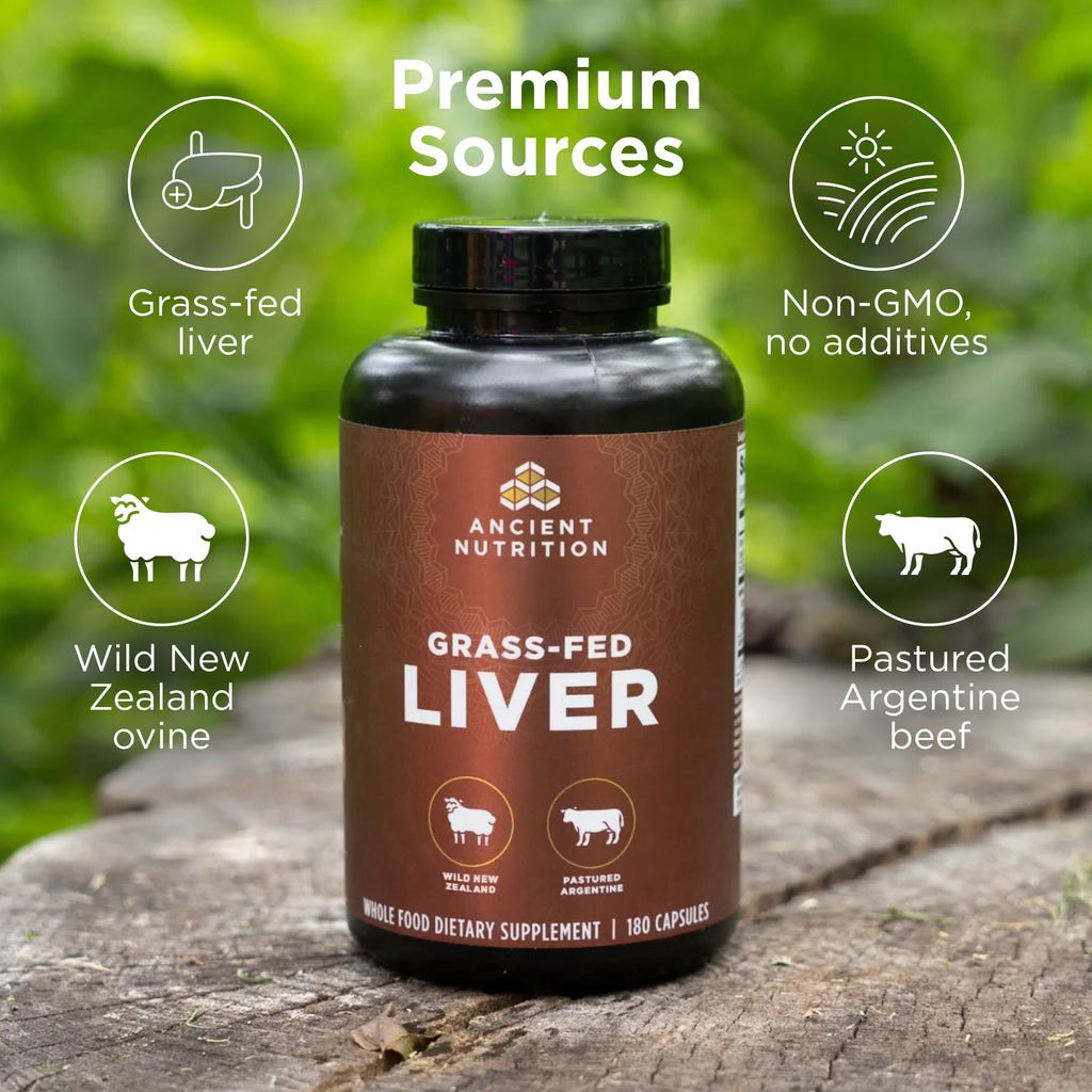Bottle of Ancient Nutrition Grass-Fed Liver supplement on a wooden surface with greenery in the background