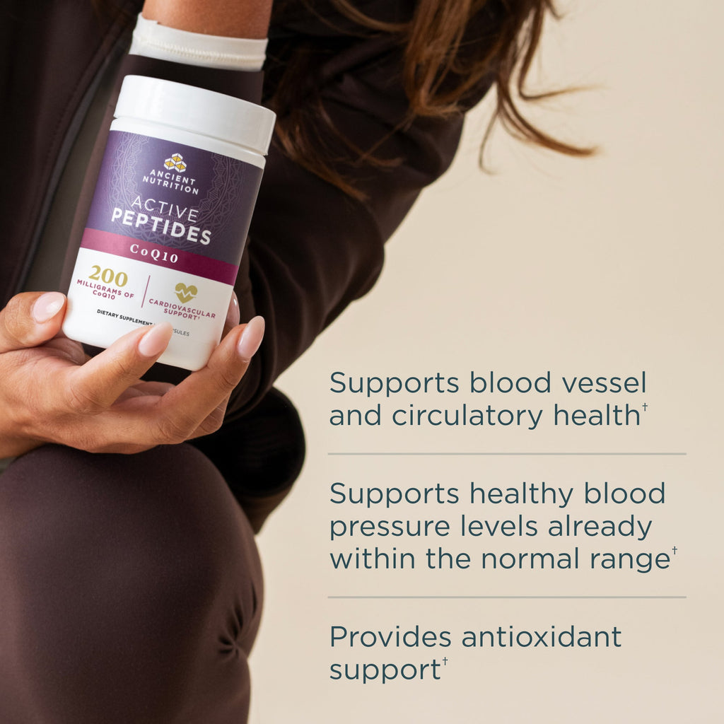 A person holds a white and purple bottle Active Peptides CoQ10 Capsule (30 Servings) with text callouts on the right detailing its health benefits.