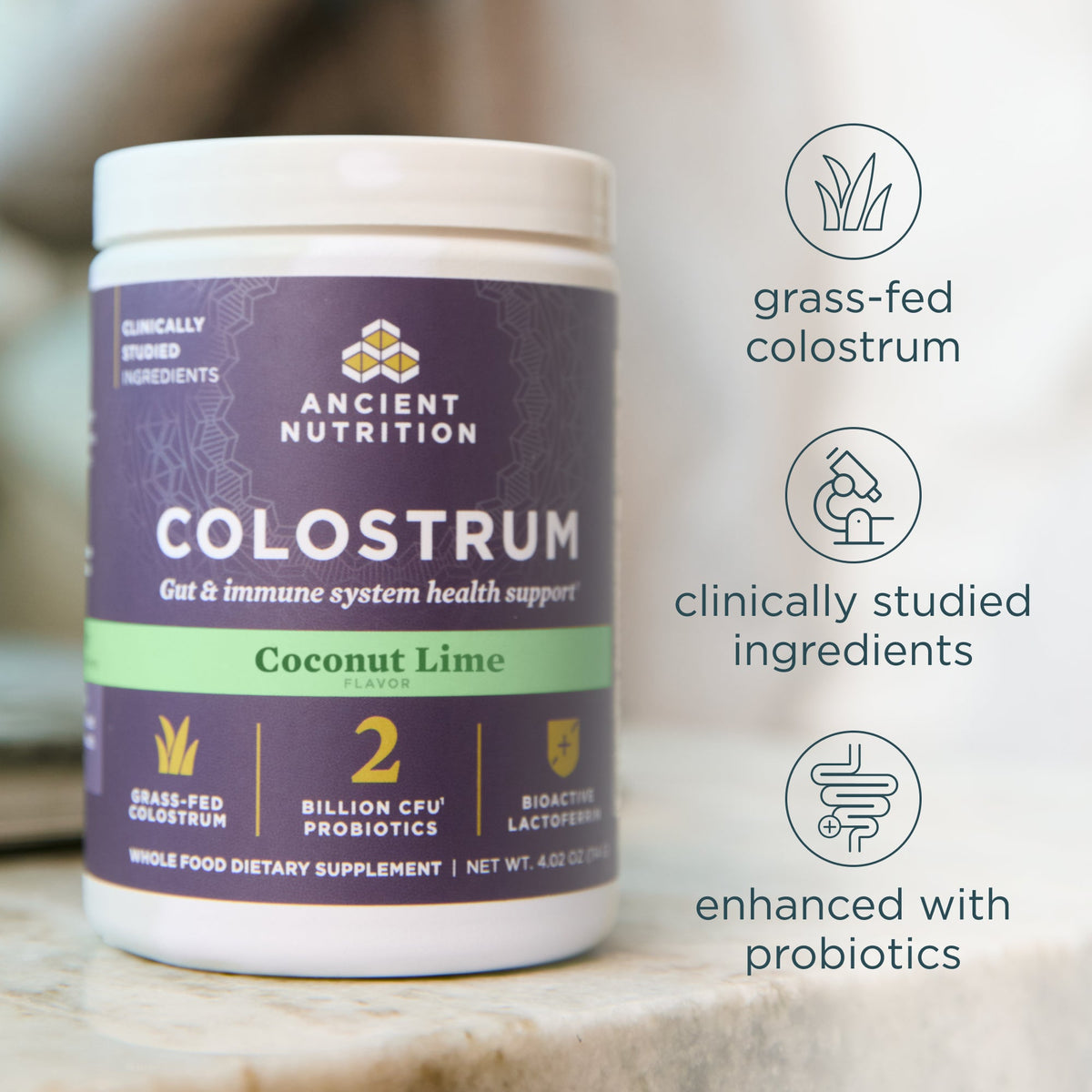 Colostrum Powder Coconut Lime Flavor (60 Servings) container shown on a marble surface with three feature callouts on the right.