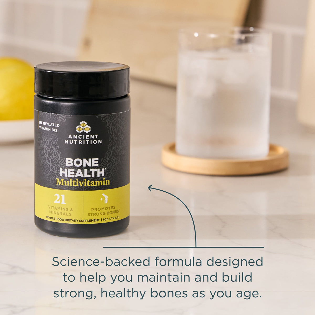 Ancient Nutrition Bone Health Multivitamin bottle on a table with text about bone health.