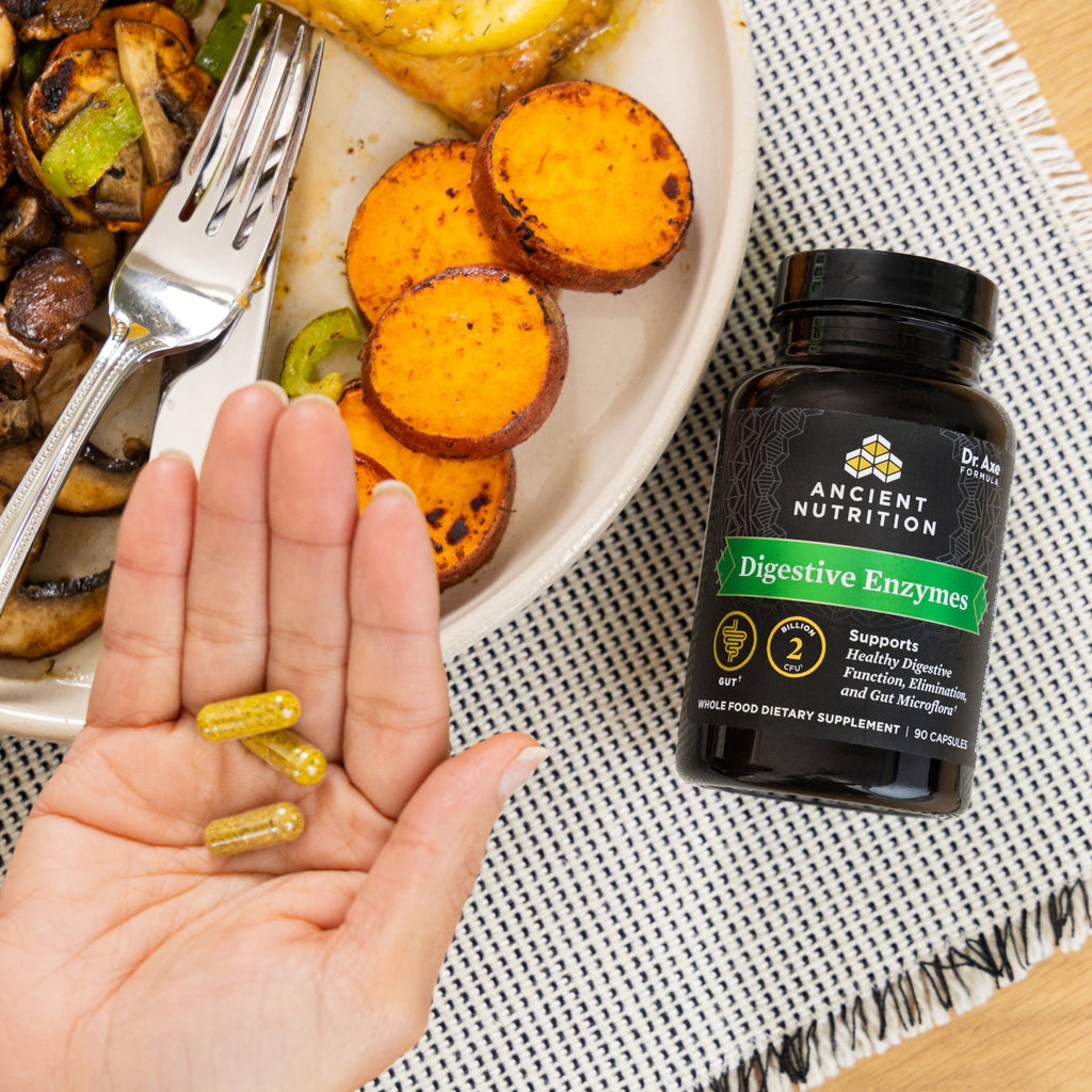 a bottle of Digestive Enzyme Capsules next to a bowl of veggies 
