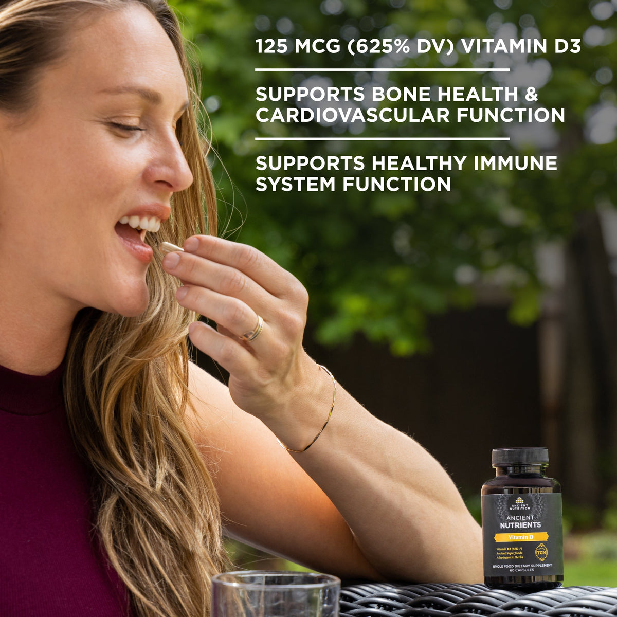 a woman taking Ancient Nutrients Vitamin D3 + K2 Capsules 