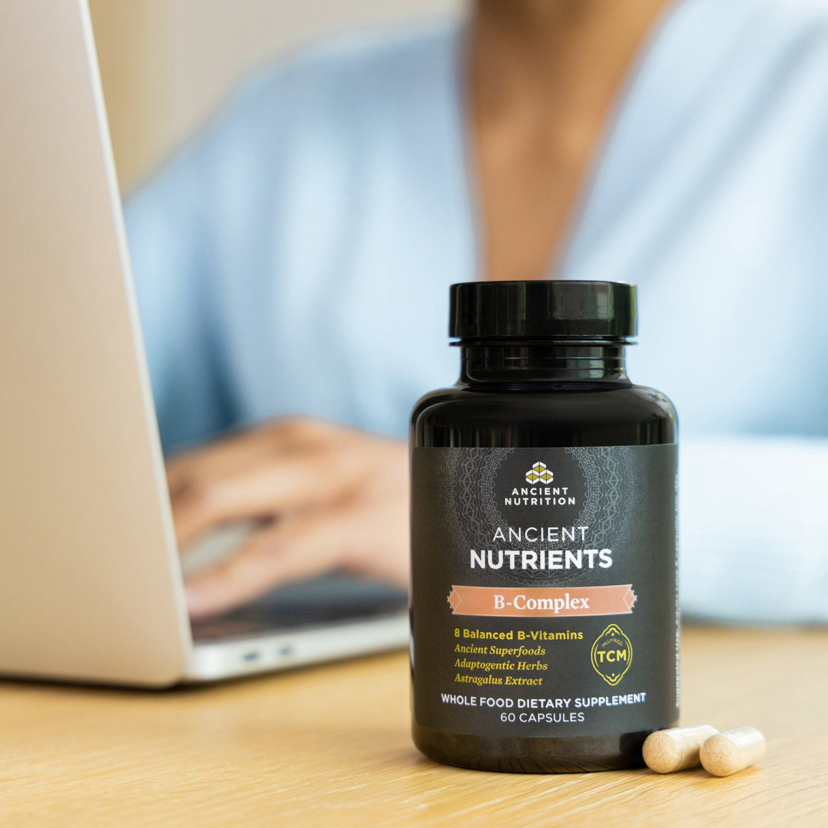 a bottle of Ancient Nutrients Vitamin B Complex Capsules (30 Servings) on a desk