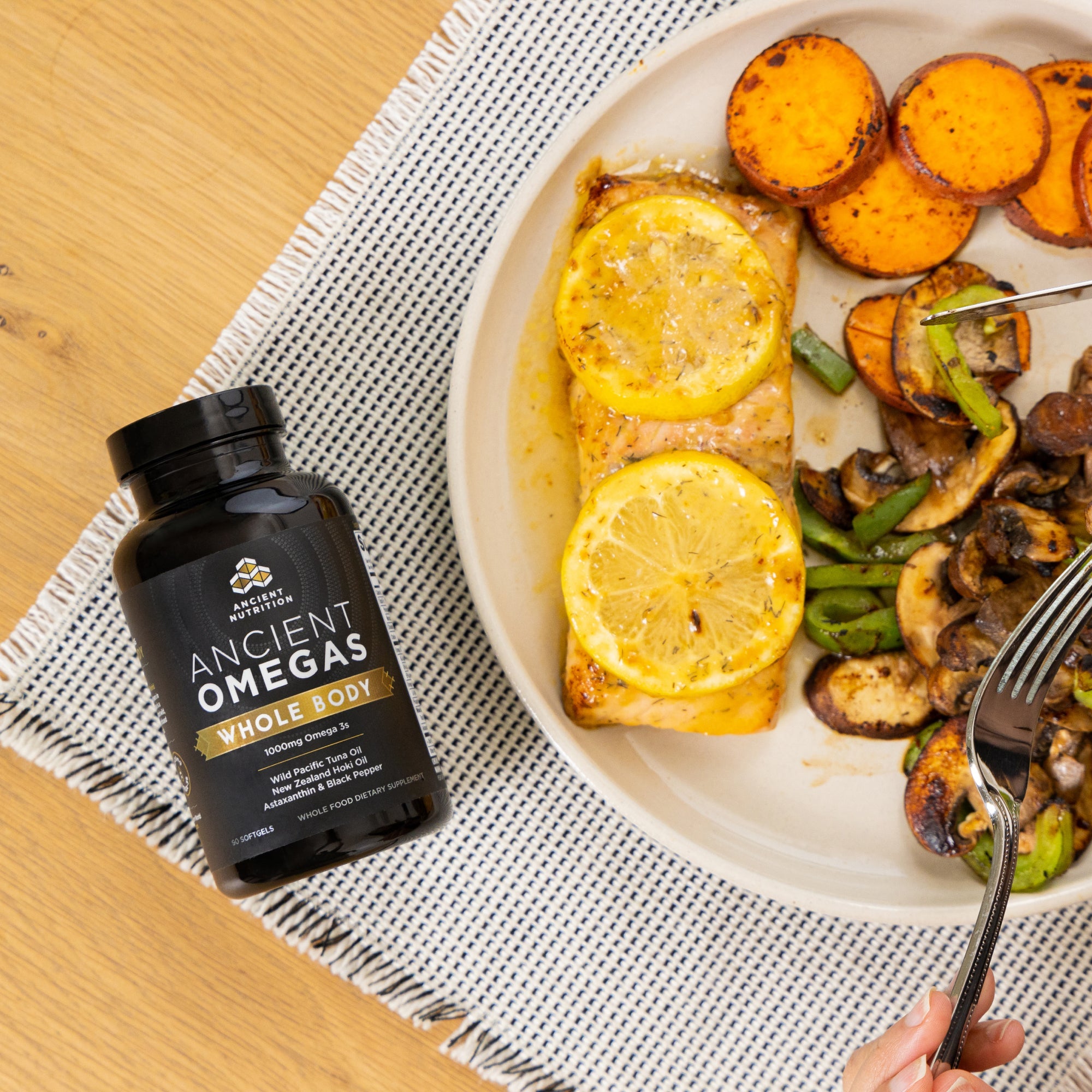 Omega-3s Whole Body bottle next to a plate of food