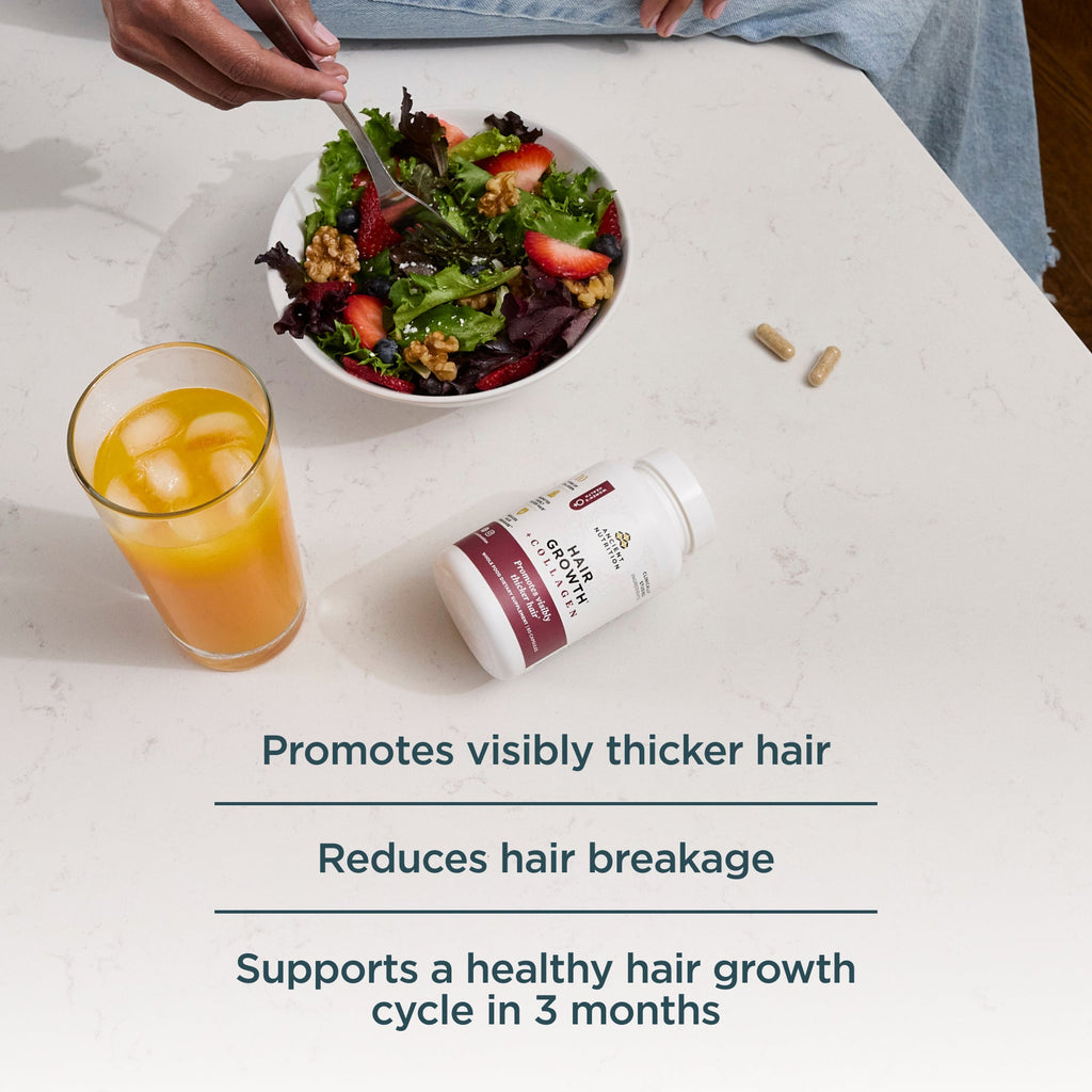 a bottle of Hair Growth + Collagen Capsules next to a salad and a turmeric drink