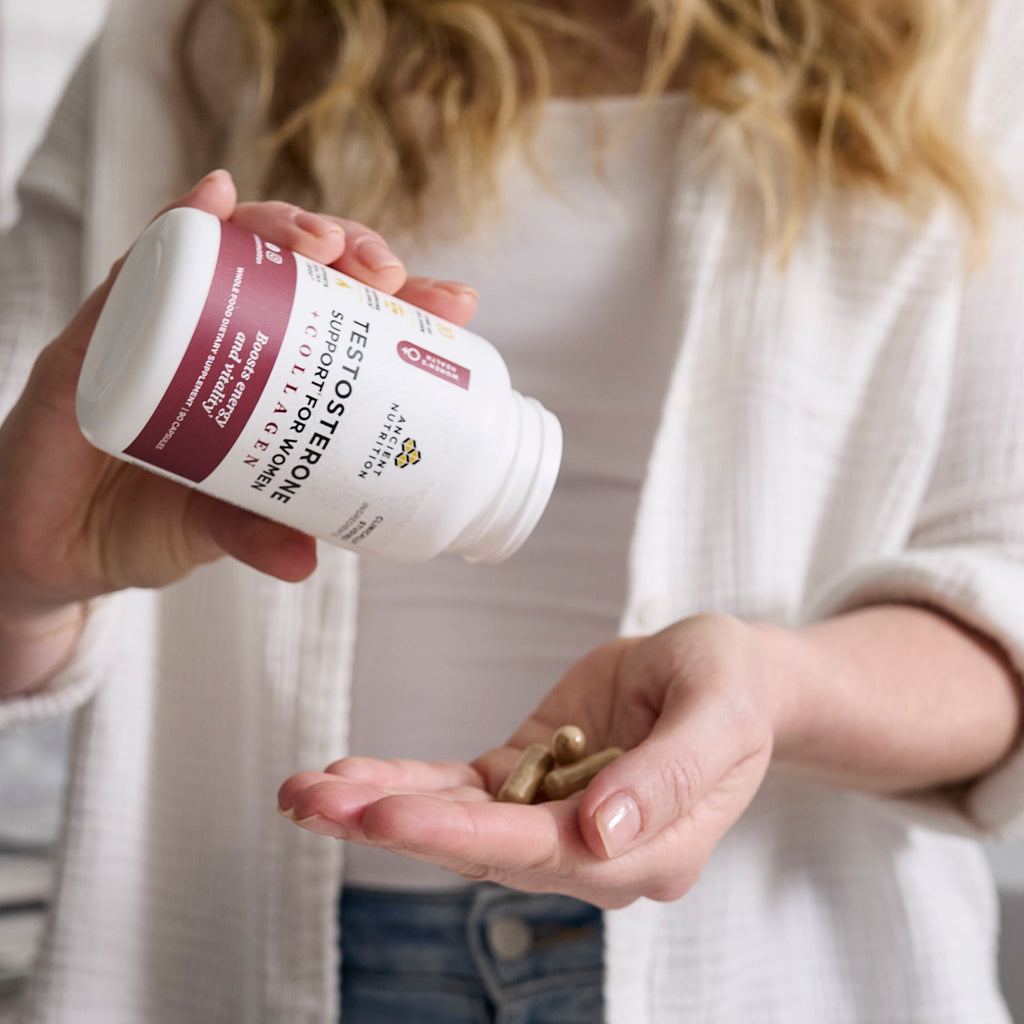 a person with Testosterone Support for Women + Collagen Capsules in their hand