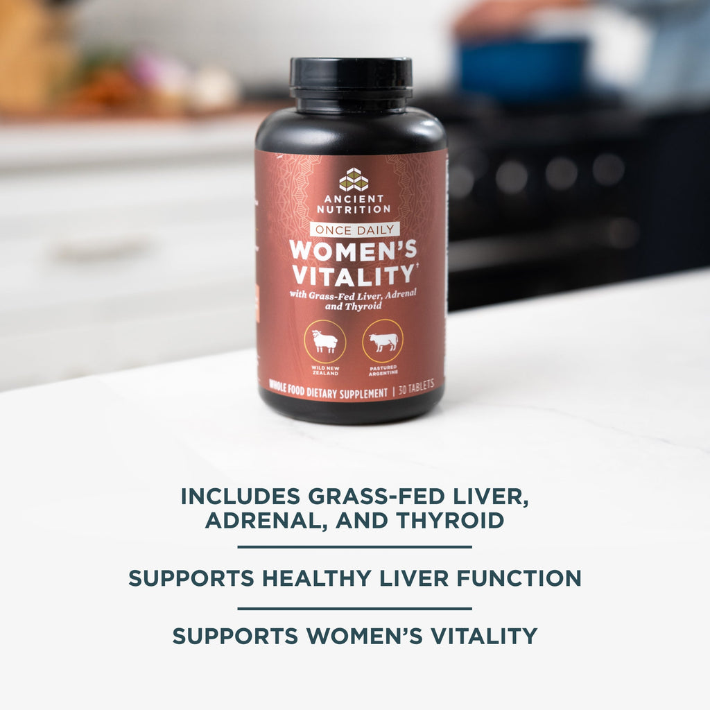 a Women's Vitality Once Daily Tablets on a white counter top