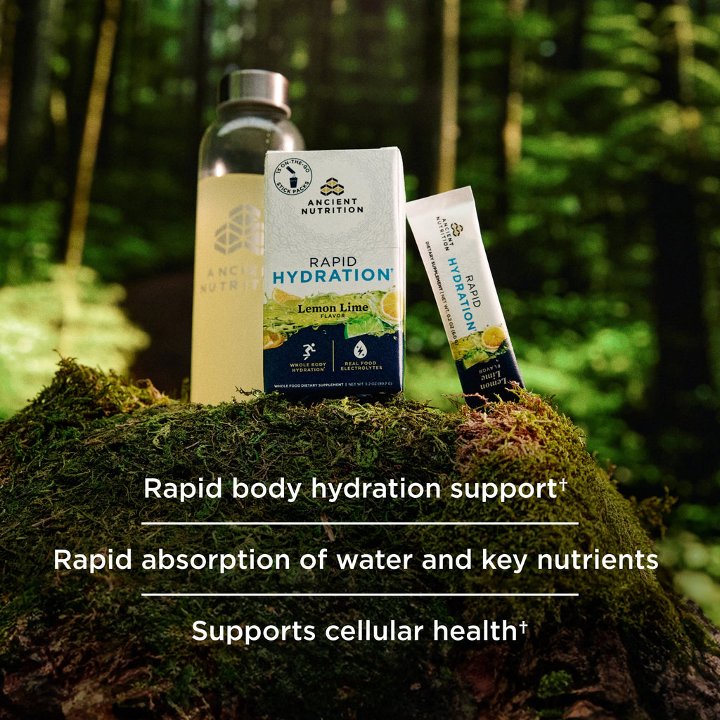 a box of Rapid Hydration Powder Lemon Lime Flavor stick packs on a mossy tree stump