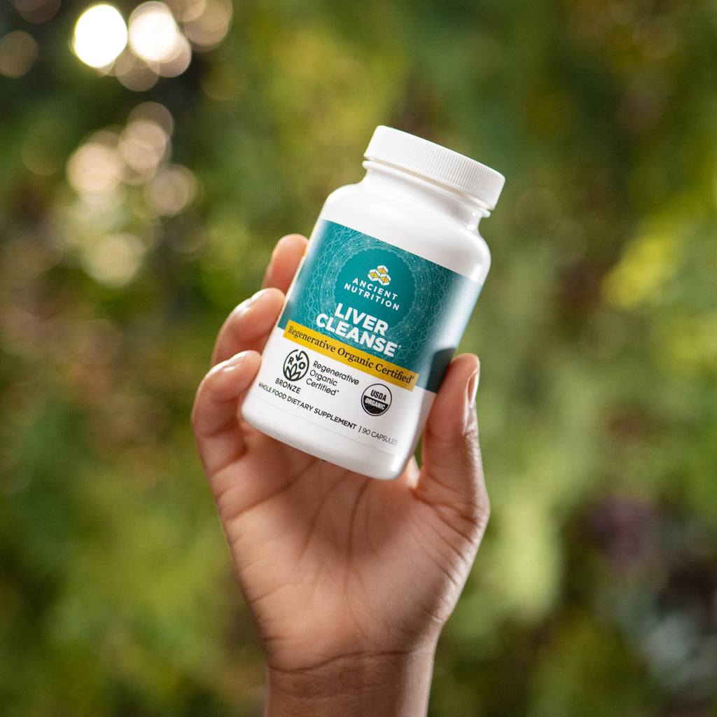 a person holding a bottle of Regenerative Organic Certifiedª Liver Cleanse