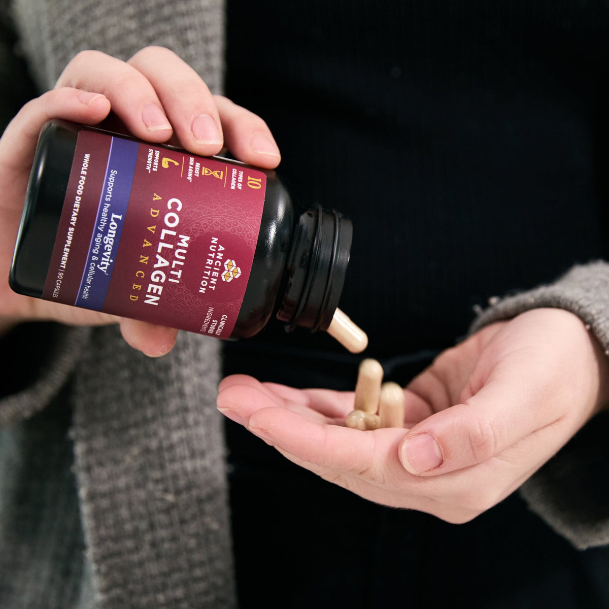 a person taking Multi Collagen Advanced Longevity† Capsules (30 Servings) 