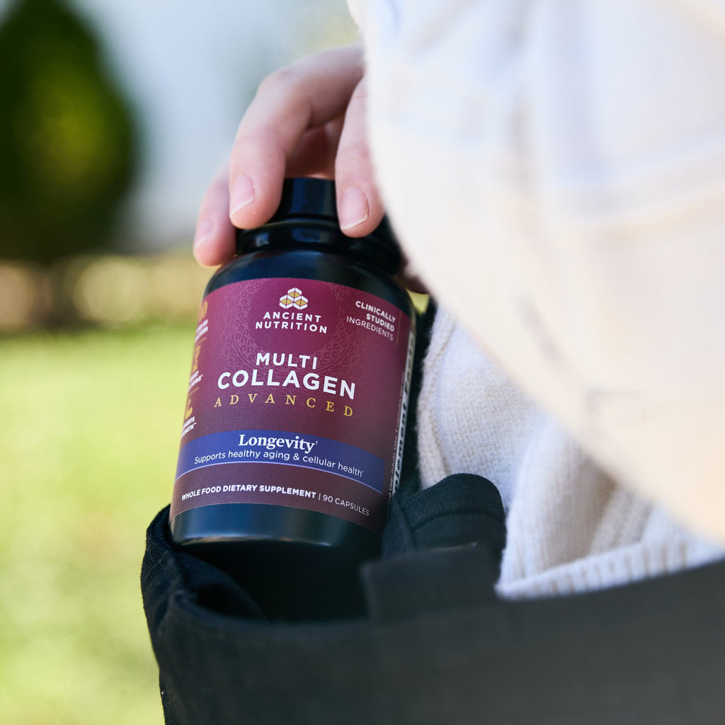 a bottle of Multi Collagen Advanced Longevity† Capsules (30 Servings) coming out of someones bag