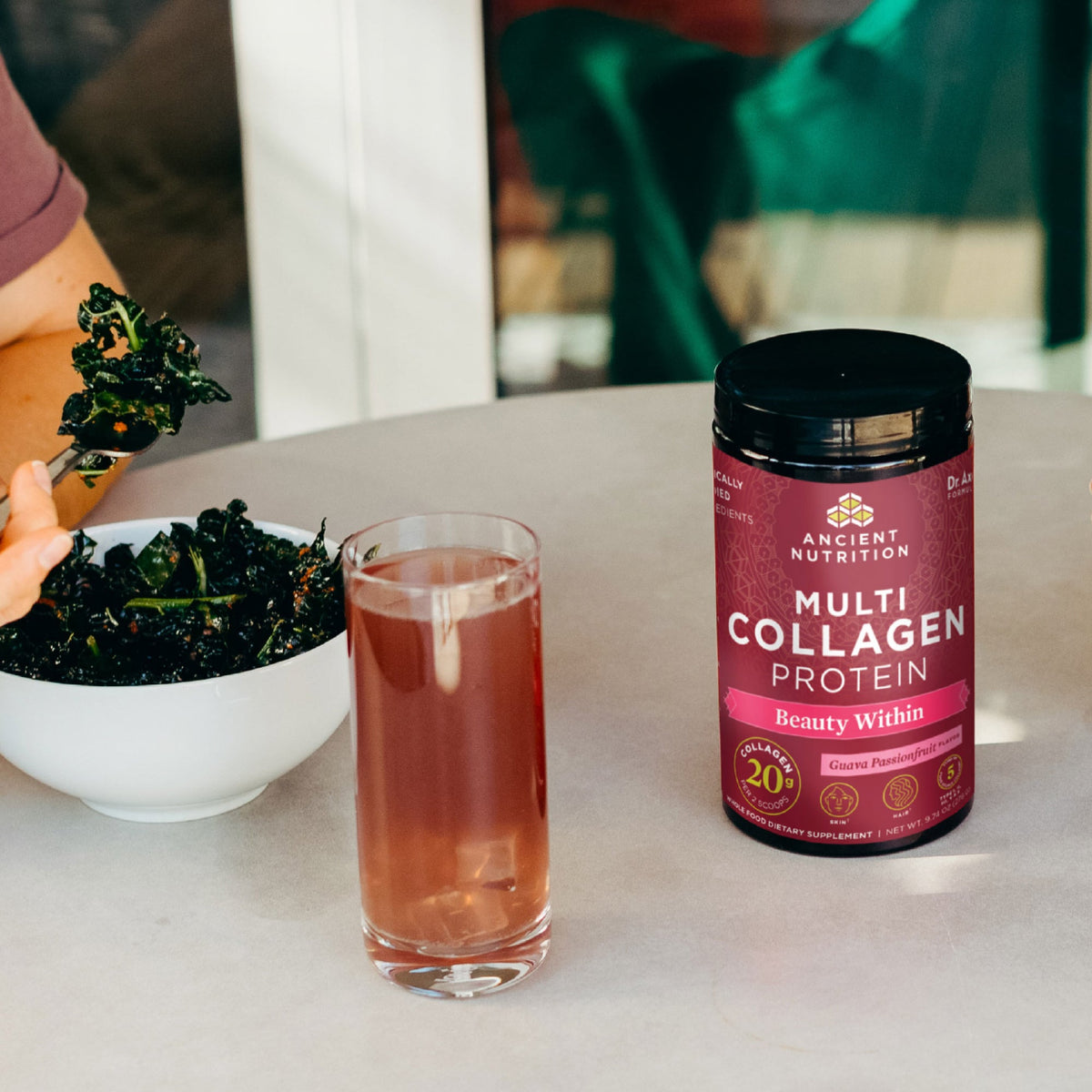 Multi Collagen Protein Beauty Within Powder bottle next to a kale salad