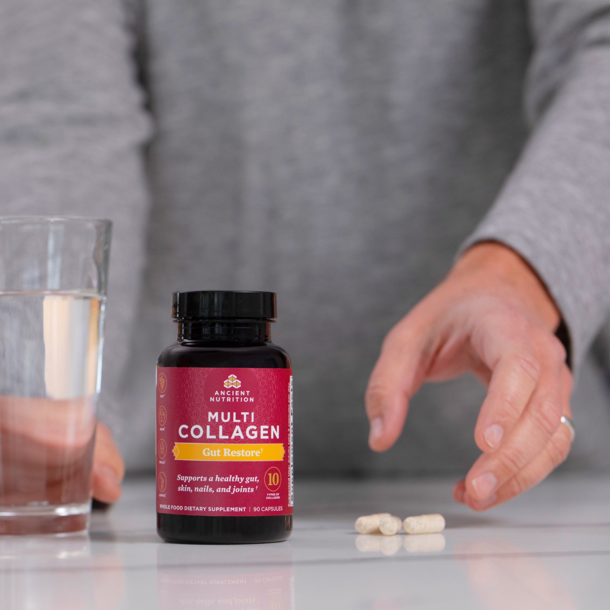 person taking Multi Collagen Gut Restore Capsules (90 Capsules)
