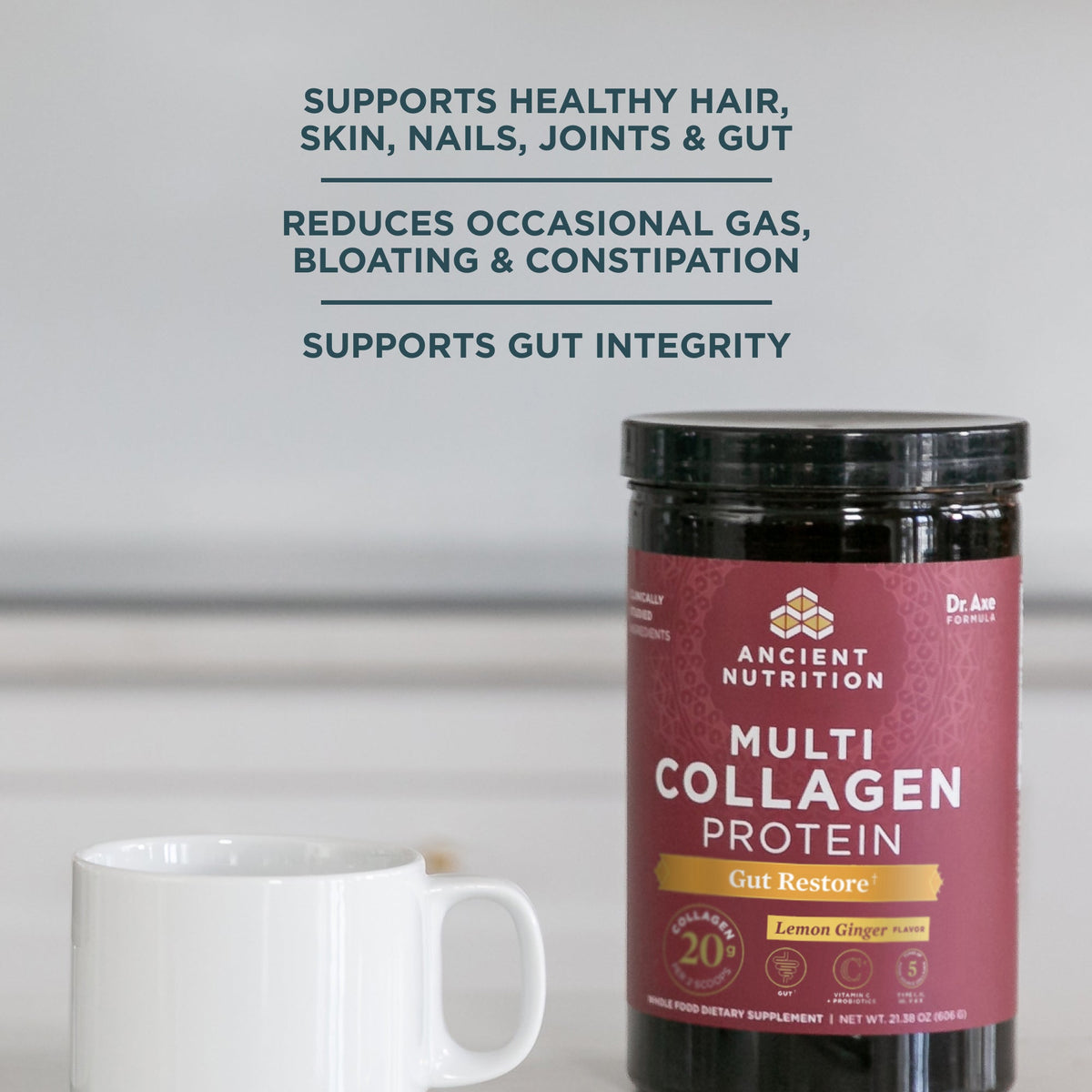 Multi Collagen Protein Gut Restore Powder Lemon Ginger (20 Servings) bottle next to a coffee mug