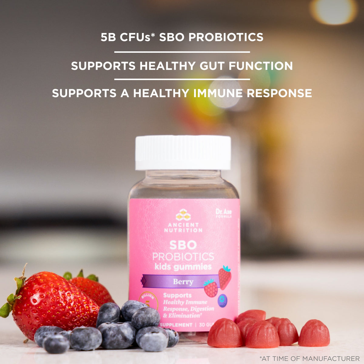 a bottle of SBO Probiotics Kids Gummies Berry surrounded by fresh fruit