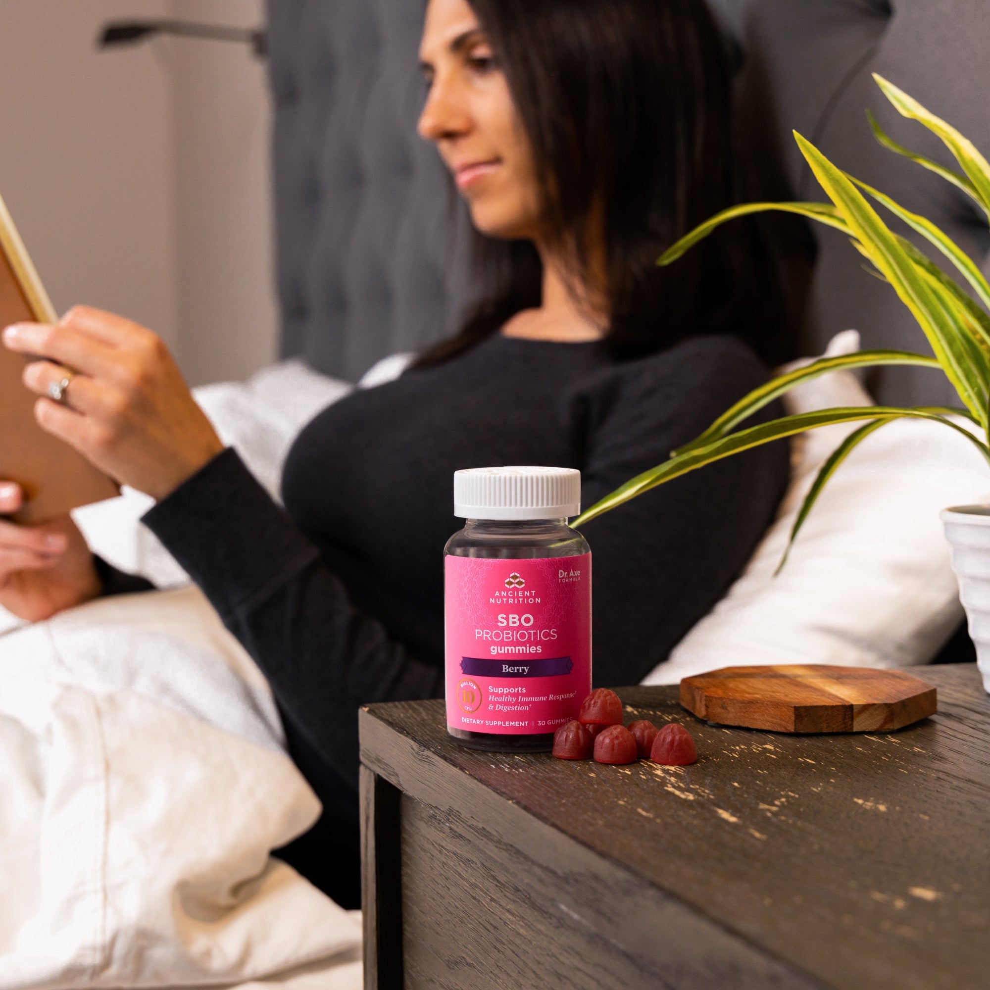 a bottle of SBO Probiotics Gummies Berry (60 Gummies) on a nightstand