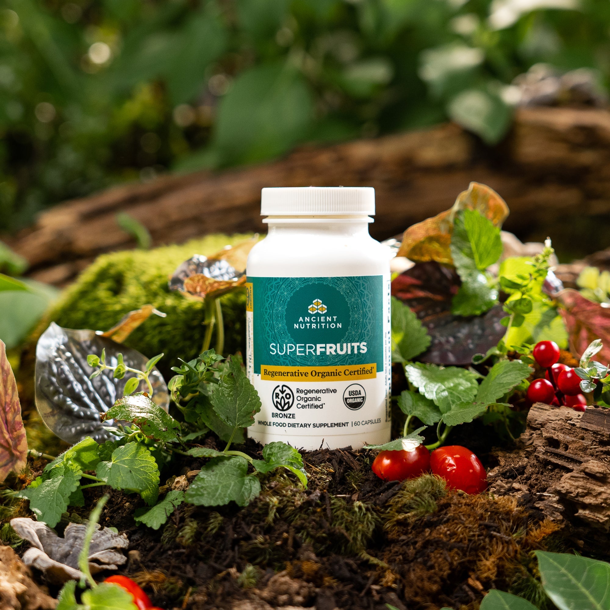 a bottle of Regenerative Organic Certifiedª SuperFruits on a mossy rock