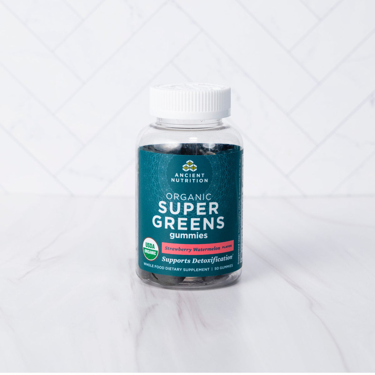Organic Super Greens Gummies Strawberry Watermelon Flavor on a marble background