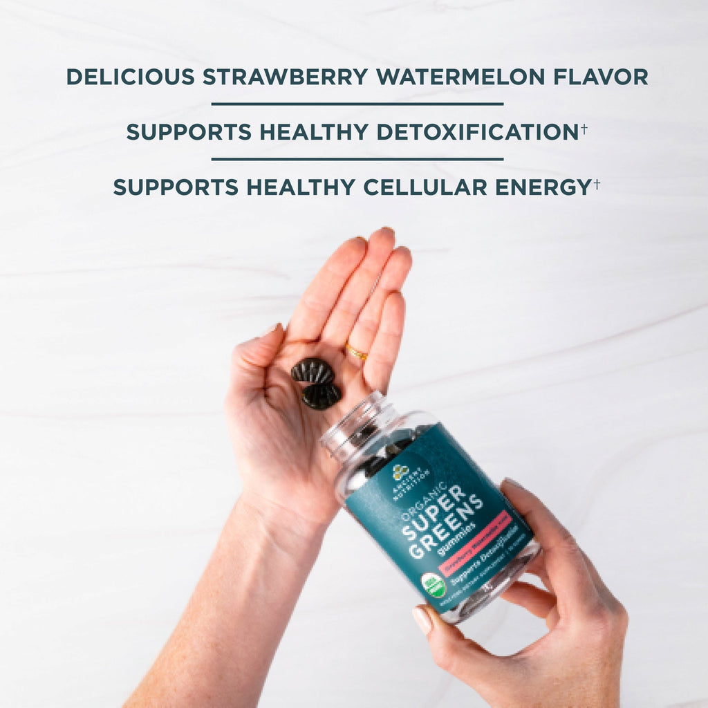 a person putting Organic Super Greens Gummies Strawberry Watermelon Flavor in their hand