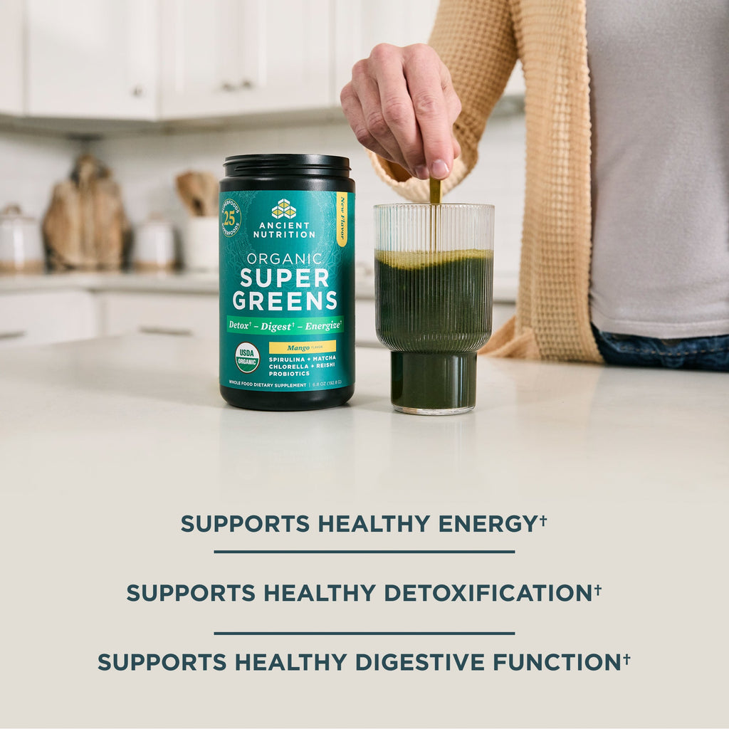 Organic SuperGreens Powder Mango Flavor (25 Servings) on a kitchen counter