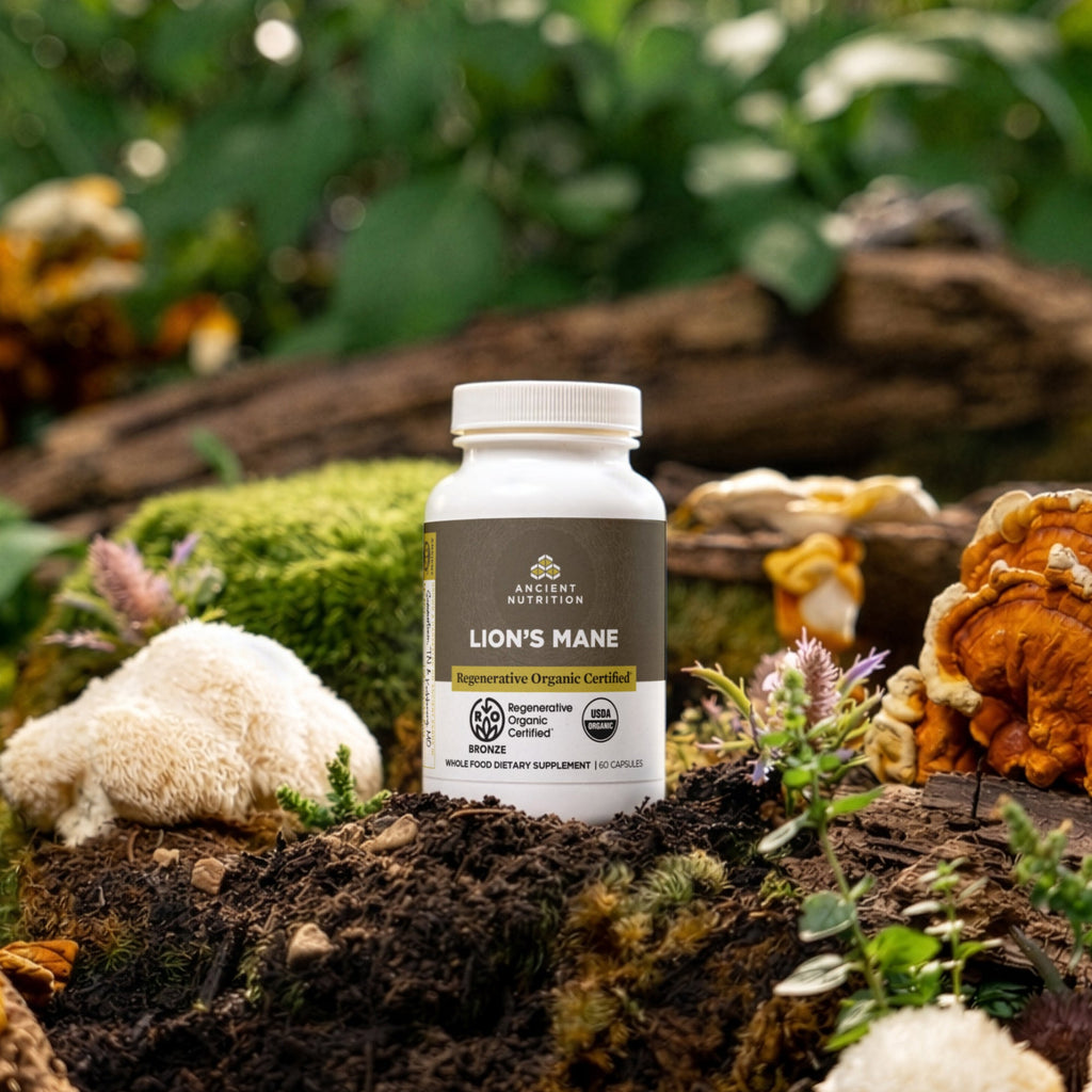 a bottle of Regenerative Organic Certified® Lion's Mane Capsules on a mossy tree log