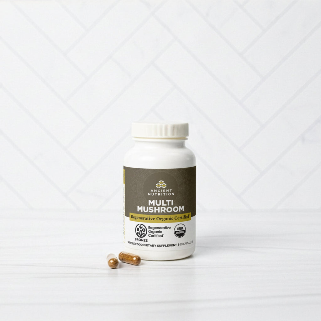 a bottle of Regenerative Organic Certified® Multi Mushroom Capsules on a marble counter